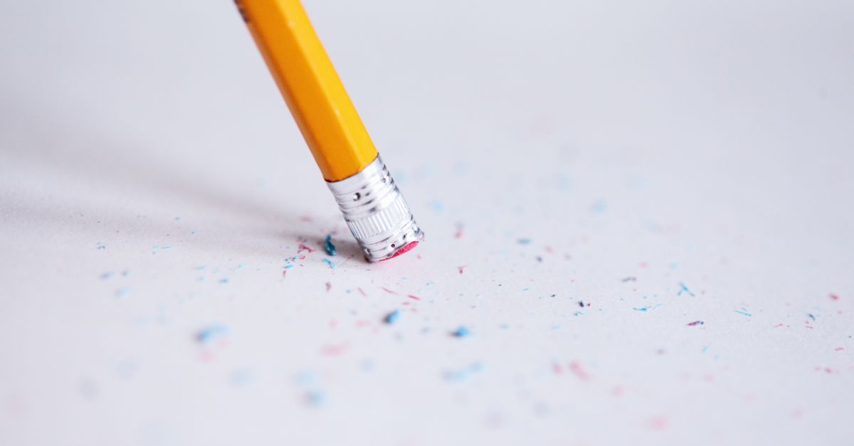A pencil and eraser correcting a mistake on paper
