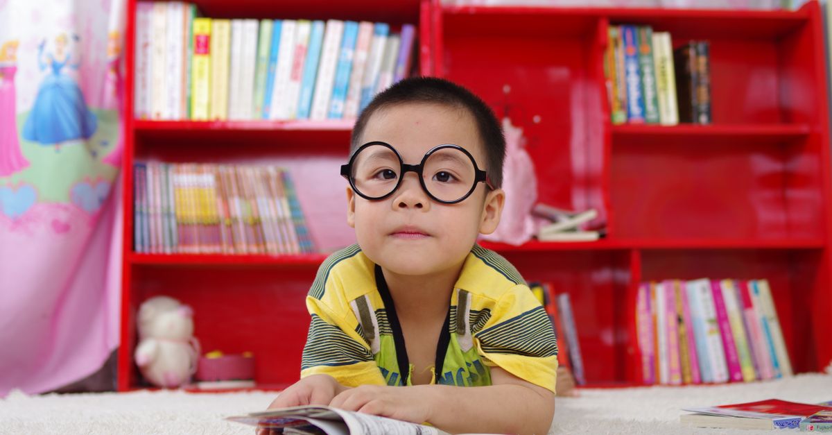 A young student reading a book and building vocabulary