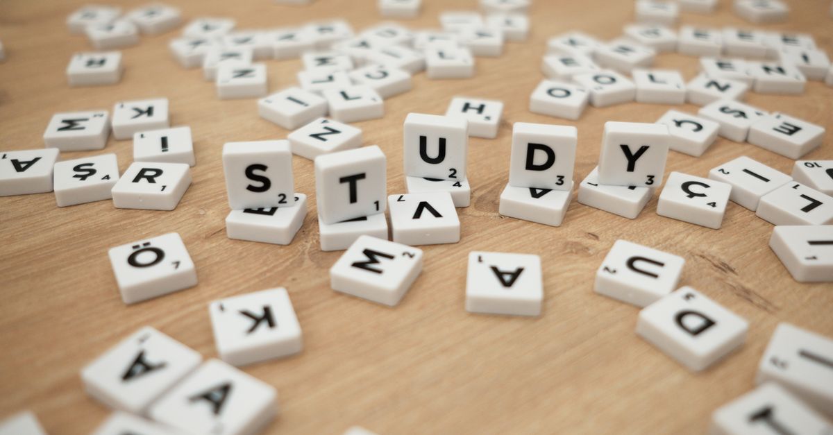 Scrambled letter tiles scattered across a table