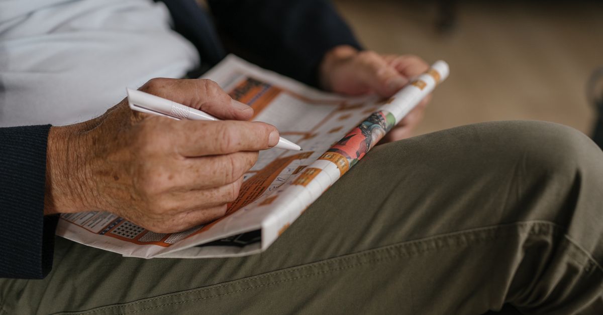 A crossword puzzle being solved with a pencil