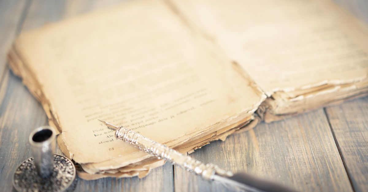 An antique manuscript and quill pen evoking the history of wordplay