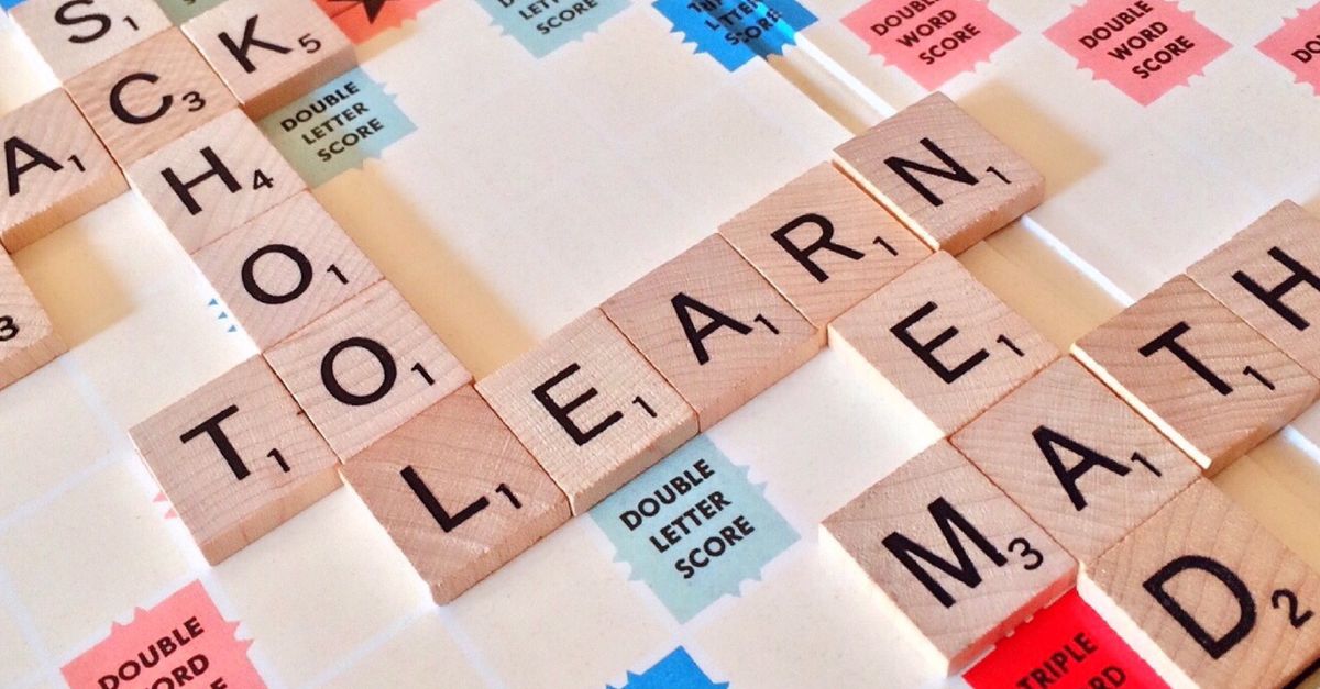 Letter tiles laid out for solving a long word puzzle