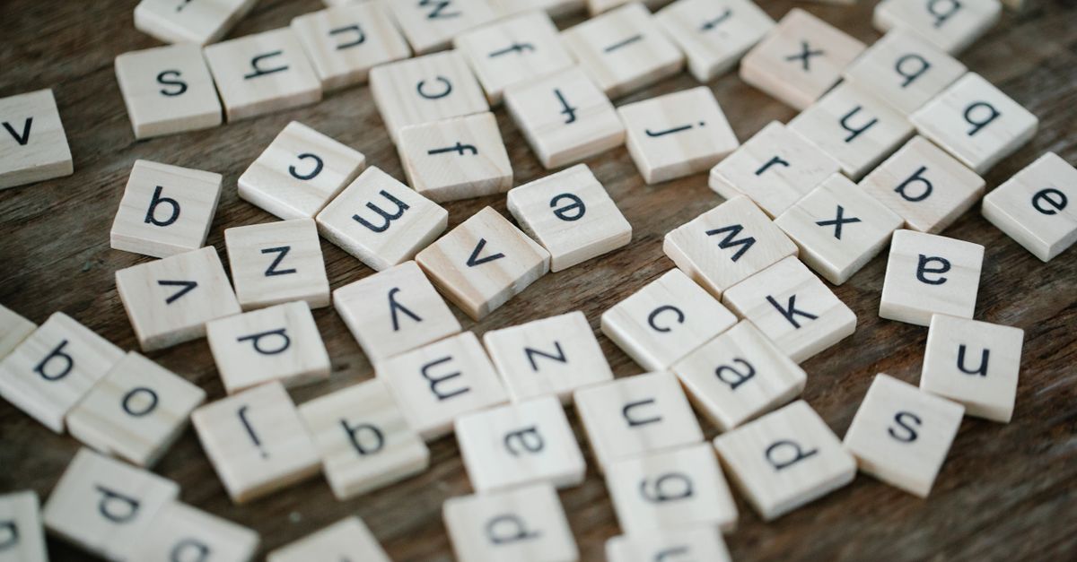 Close-up of wooden alphabet tiles showing letters